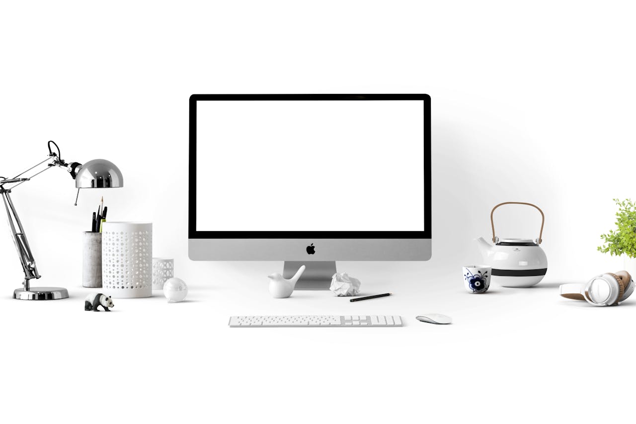 services-02 Minimalist office desk with an iMac, lamp, and stationary, perfect for tech backgrounds.