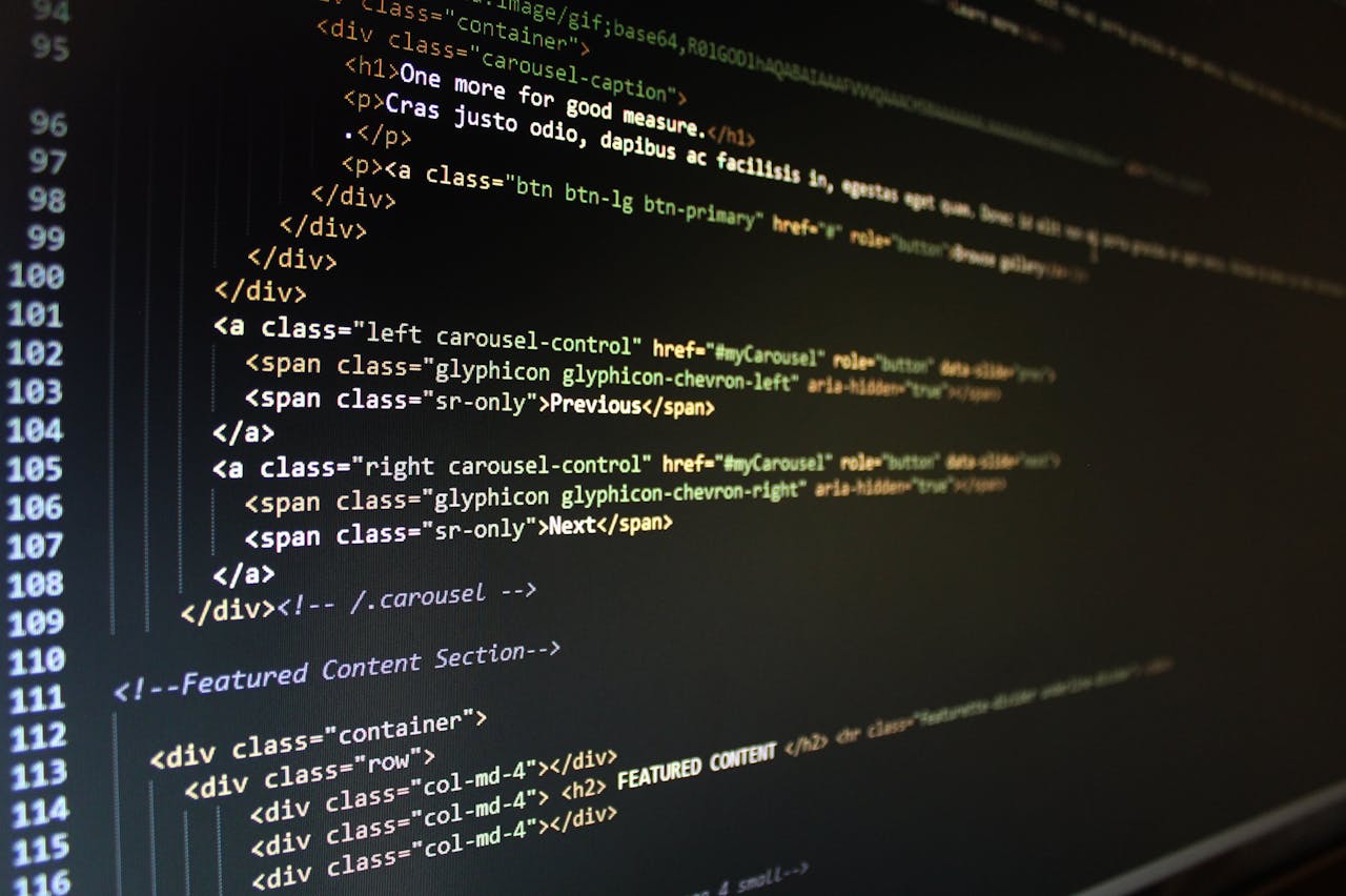 services-04 Close-up of HTML code displayed on a computer monitor, showcasing web development.