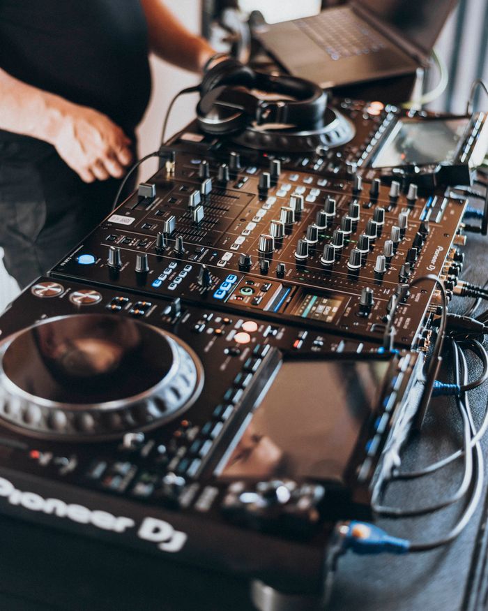 services-04 Professional DJ operating modern mixing equipment during an indoor event.
