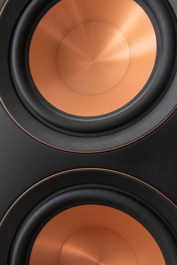 who-we-are High-quality close-up of copper speaker drivers, emphasizing premium audio technology and design.