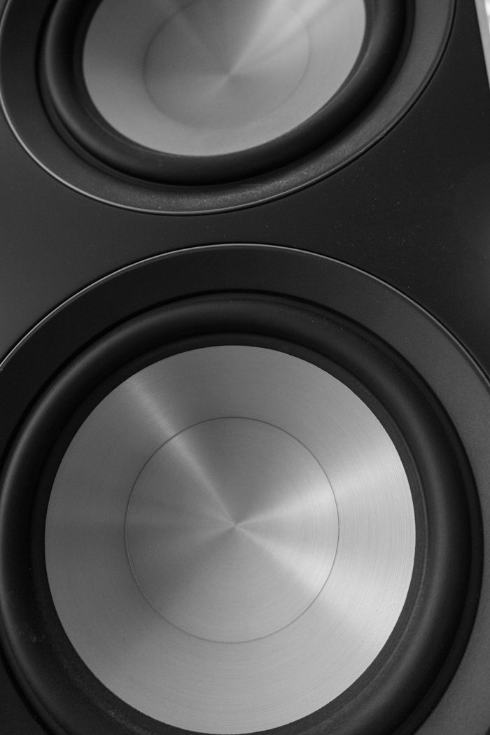 journey High-contrast black and white photo of modern speaker cones exhibiting a sleek design.